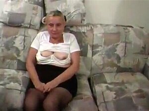 Breasty grandma looks slightly ridiculous in her taut top and short mini petticoat, but there is no doubt that that babe is damn nice in couch